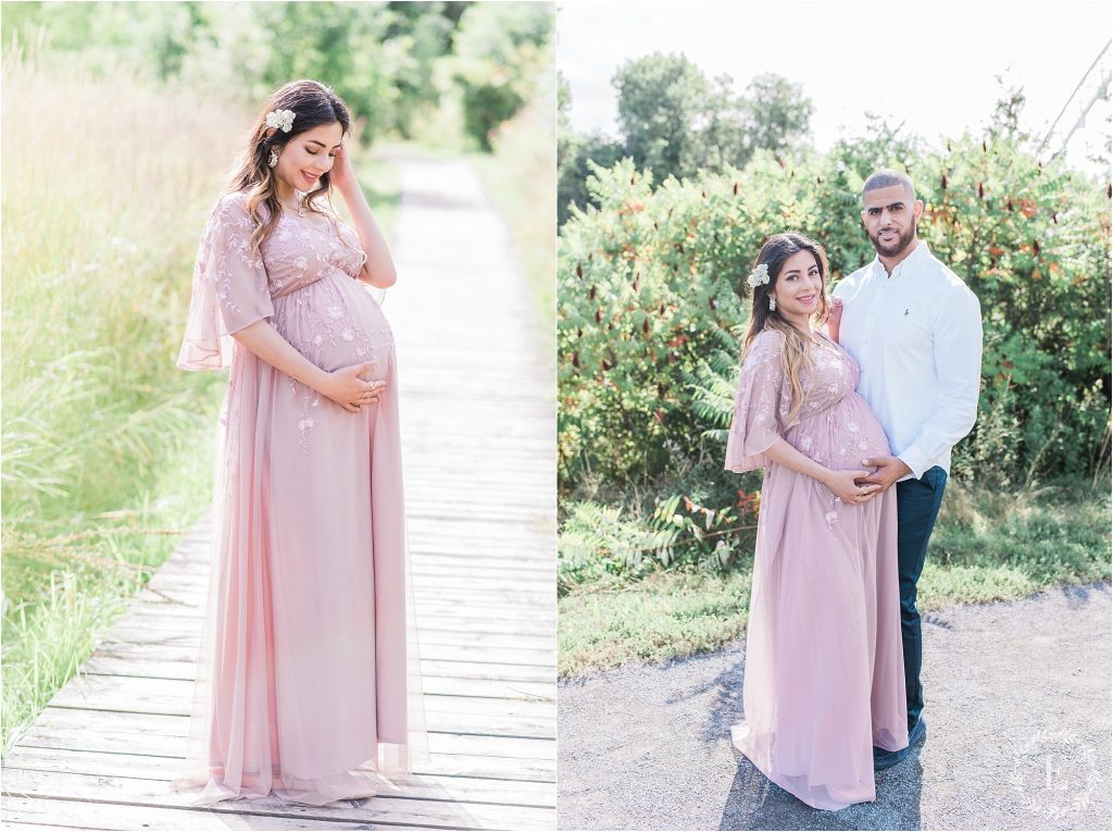 Expecting mother in a blush pink gown cradling her bump on a wooden boardwalk at Chapman Mills Conservation Area in Ottawa, surrounded by tall grasses.