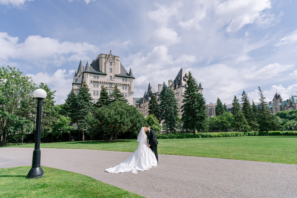 Wedding portraits in Major's Hill Park with the Fairmont Château Laurier in the background, Ottawa — photographed by Emma Haidar