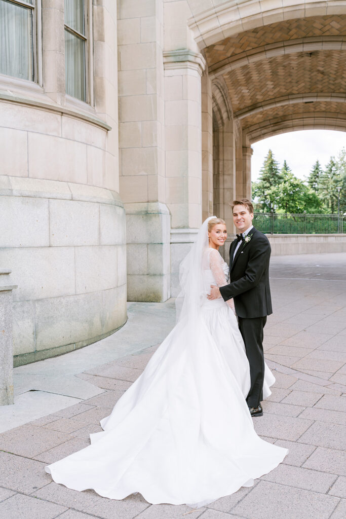 Wedding portrait against the limestone exterior of the Fairmont Château Laurier, Ottawa — photographed by Emma Haidar