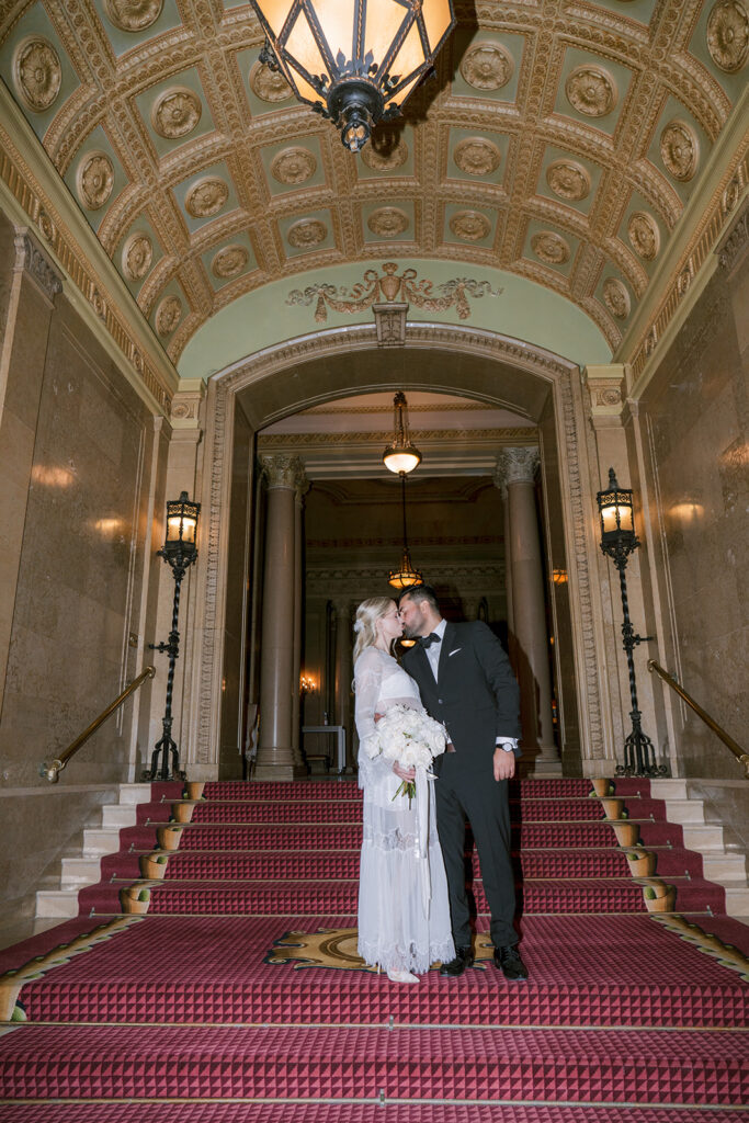 Bride and groom on the Grand Staircase at the Fairmont Château Laurier, Ottawa — photographed by Emma Haidar