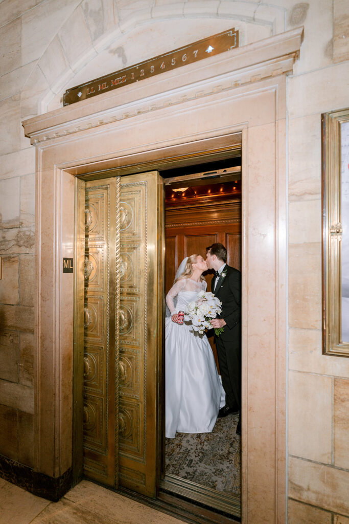 Bride and groom in the historic brass elevator at the Fairmont Château Laurier, Ottawa — photographed by Emma Haidar