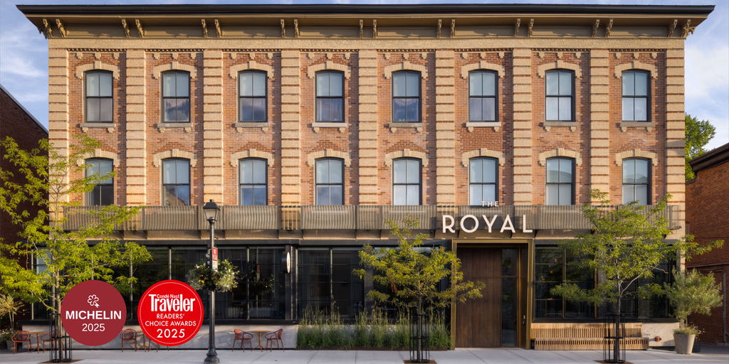 Exterior facade of The Royal Hotel, a restored Victorian red brick building with ornate stone detailing
